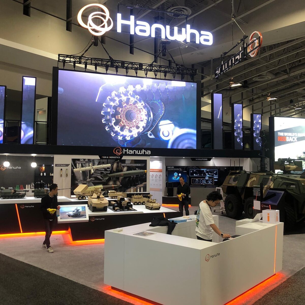 Hanwha two-story exhibit with LED wall and product displays