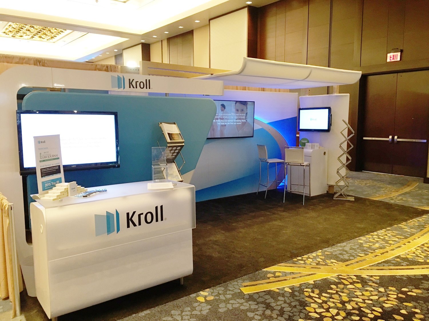 Kroll corporate booth in a hotel ballroom
